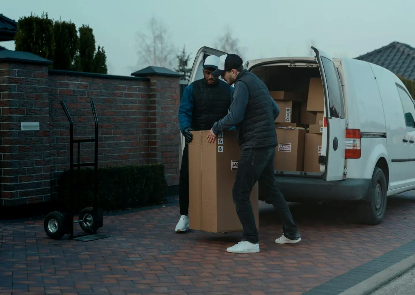 Two people moving boxes